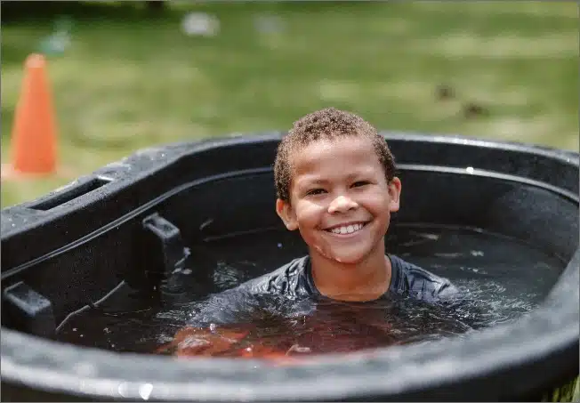 Kid smiling and playing in water